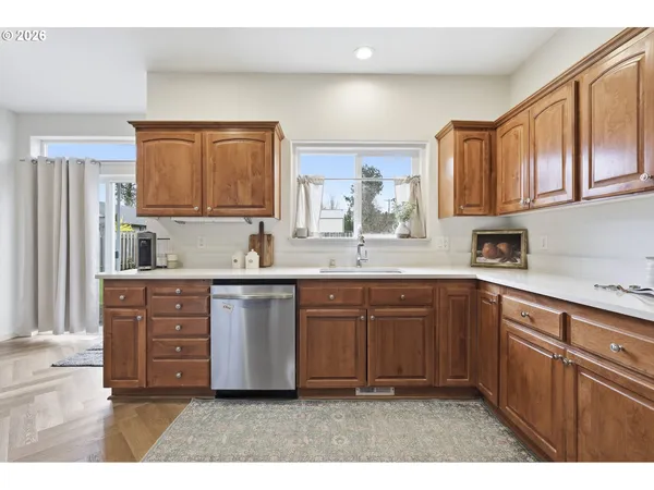 a kitchen with stainless steel appliances granite countertop a sink dishwasher stove and cabinets