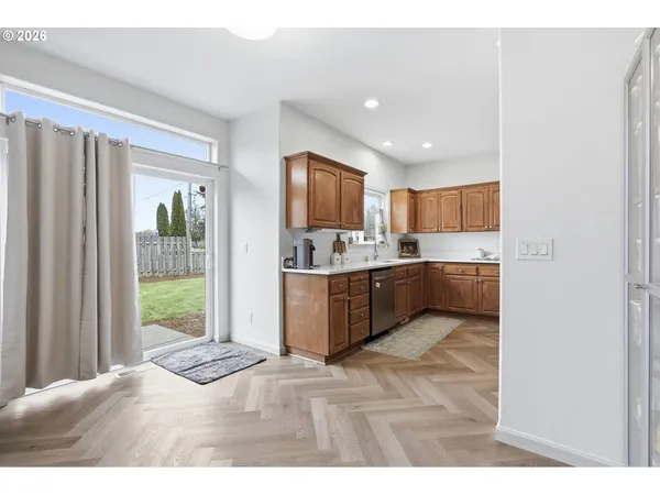 a kitchen with stainless steel appliances granite countertop a refrigerator and a sink