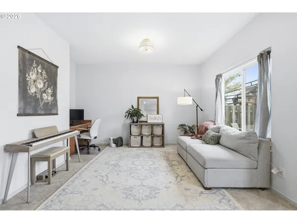 a living room with furniture and a lamp