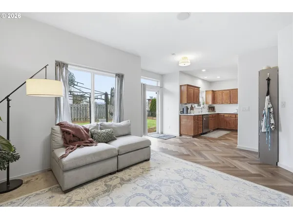 a living room with furniture and a kitchen