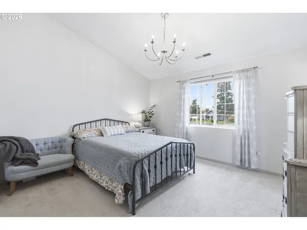 a bedroom with a bed and window