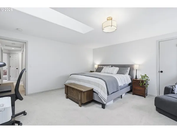 a bed room with a bed and a chair