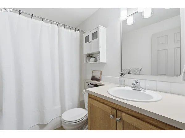 a bathroom with a sink toilet and a mirror