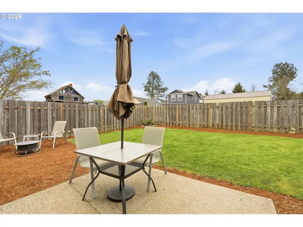 a view of a backyard with a table and chairs