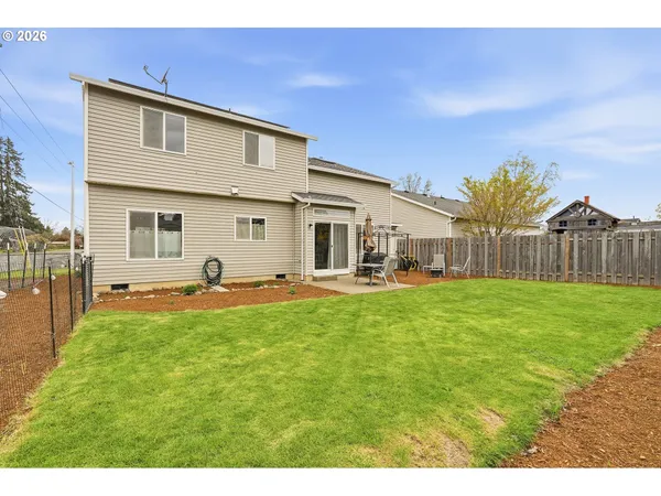 a front view of a house with yard and seating space
