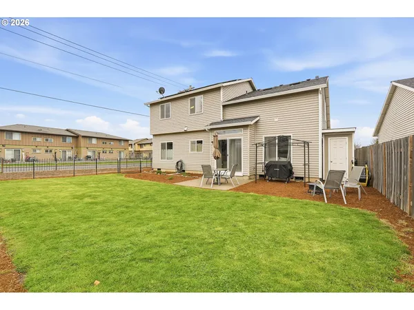 a view of a patio with table and chairs and potted plants