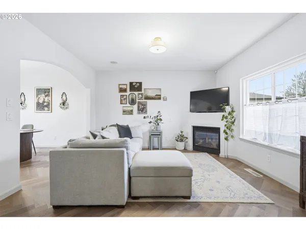 a living room with furniture a fireplace and a flat screen tv