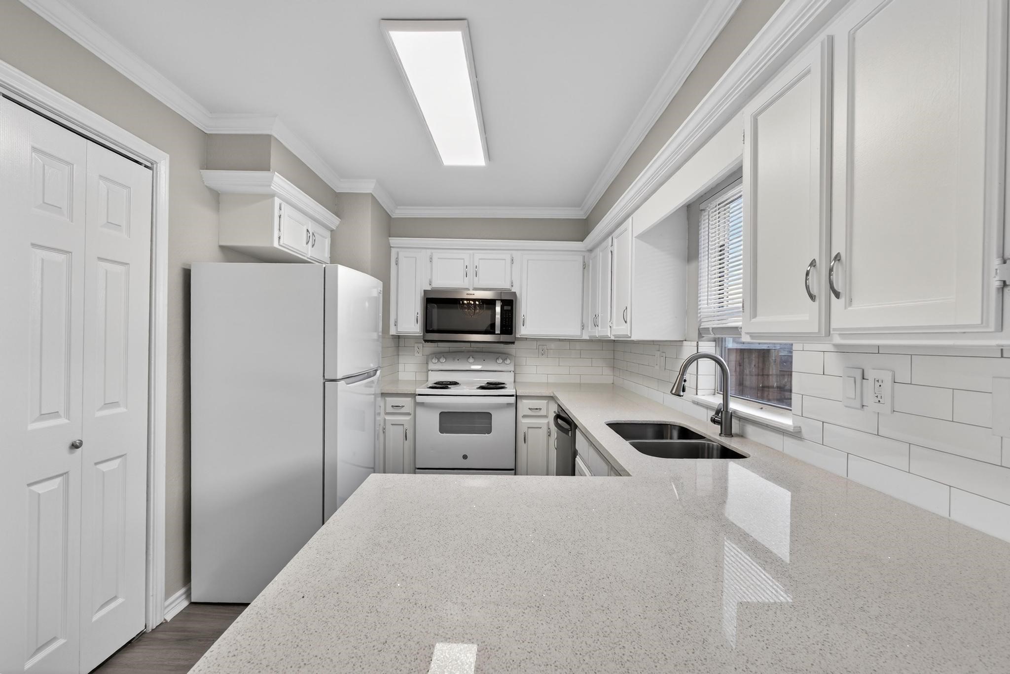 a kitchen with stainless steel appliances granite countertop a refrigerator sink and stove