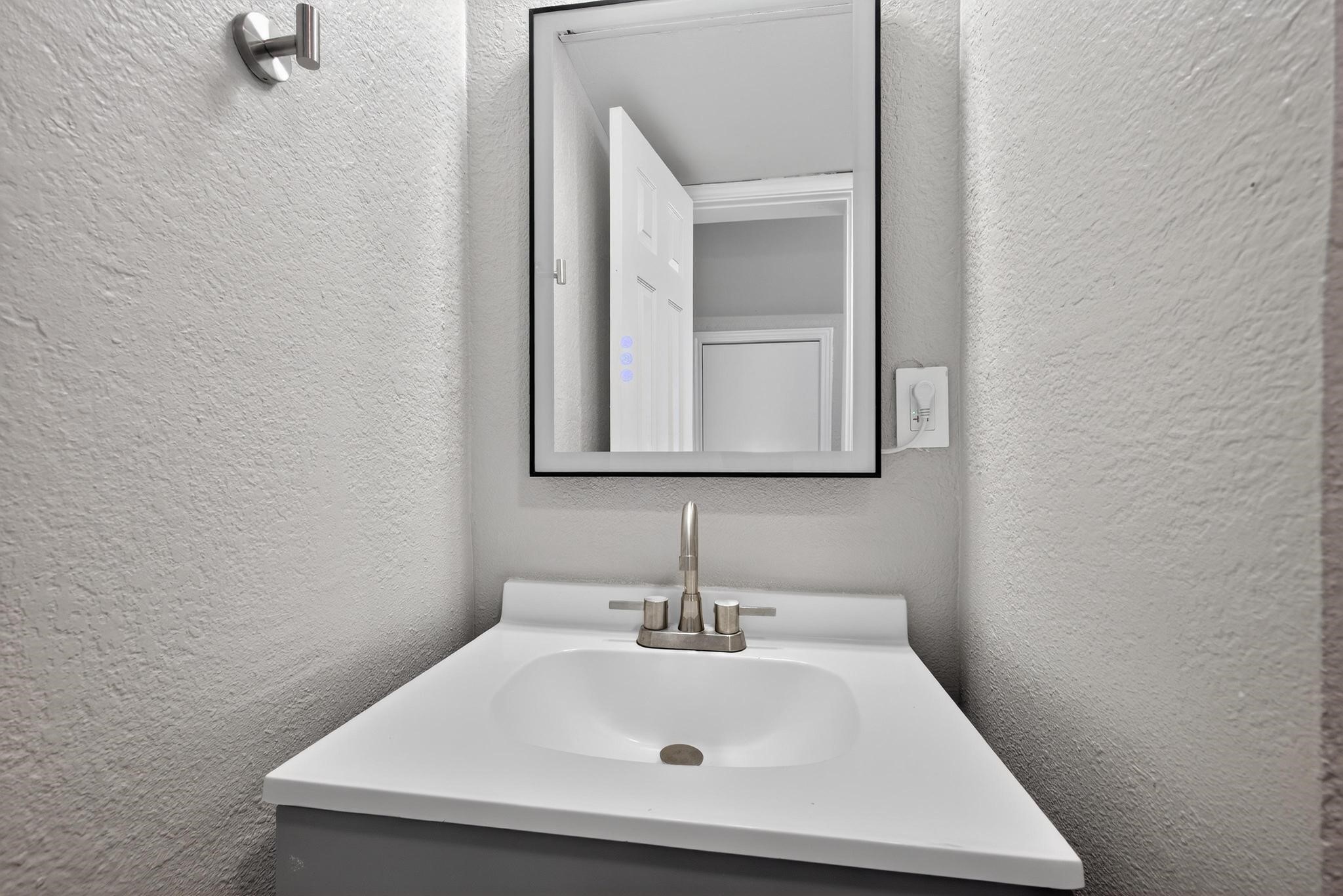 1221 Cedar Post Lane, Unit 4B Houston, TX 77055 - Photo 12 of 16 a bathroom with a sink and a mirror