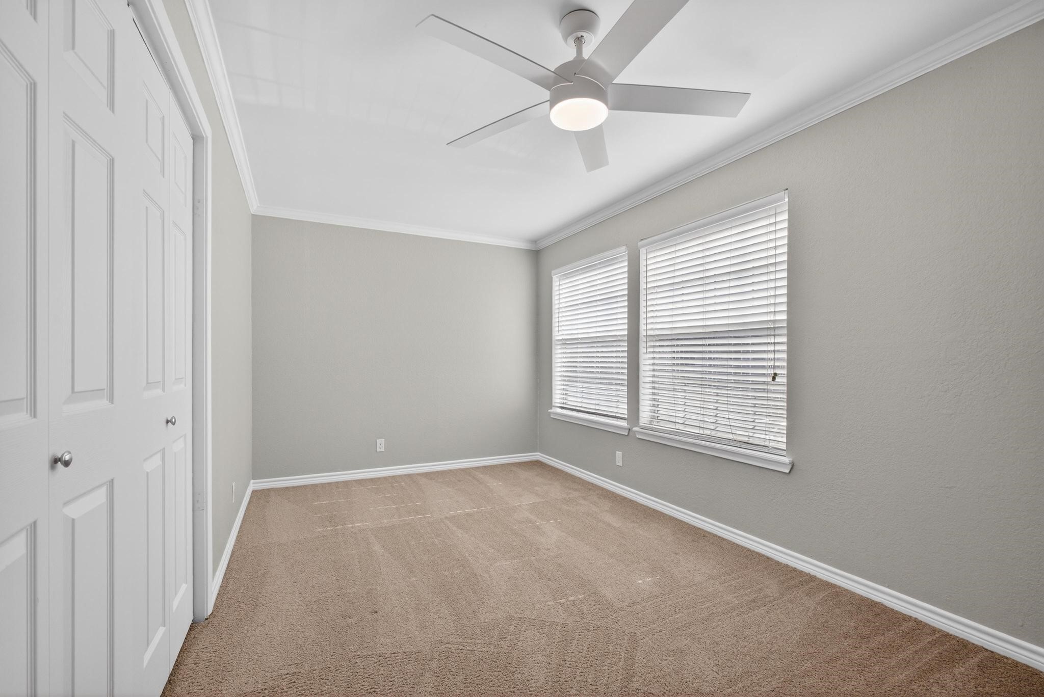 1221 Cedar Post Lane, Unit 4B Houston, TX 77055 - Photo 15 of 16 an empty room with a window and a fan