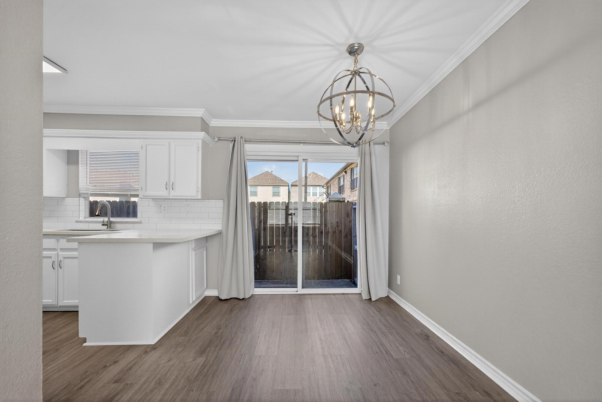 1221 Cedar Post Lane, Unit 4B Houston, TX 77055 - Photo 4 of 16 a view of an empty room with wooden floor and a window
