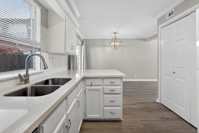 a kitchen with a sink and cabinets
