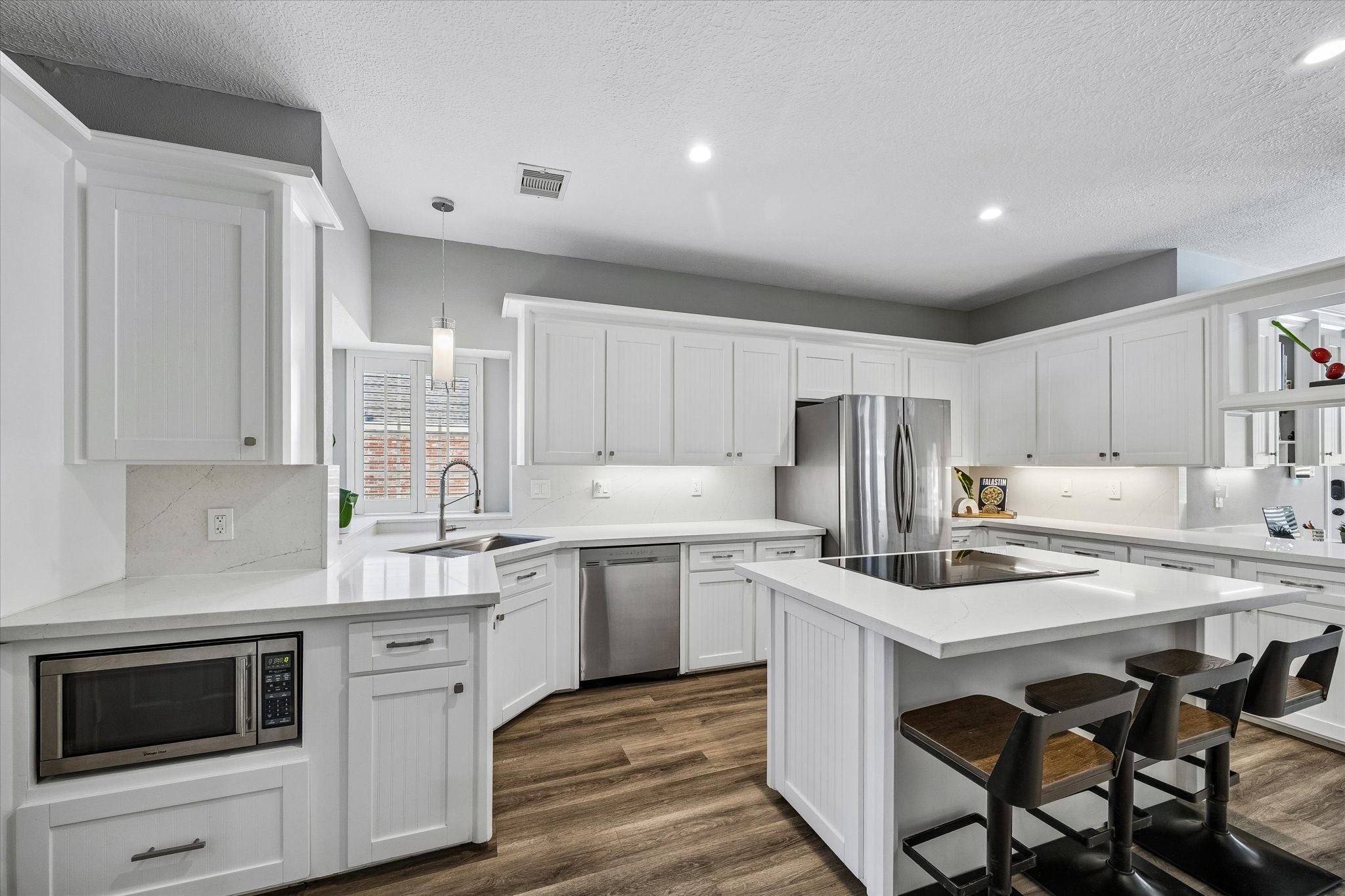 146 Golden Shadow Circle Spring, TX 77381 - Photo 16 of 41 The chef’s kitchen is conveniently located just off the dining and living rooms. Thoughtfully updated, it features bright white beadboard shaker-style cabinetry, quartz countertops, and a light, timeless design.