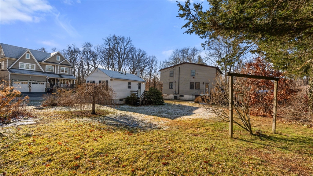 69 Hastings Road Dedham, MA 02026 - Photo 8 of 11 a front view of a house with a yard and garage