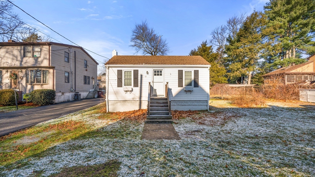 69 Hastings Road Dedham, MA 02026 - Photo 10 of 11 a front view of a house with a yard