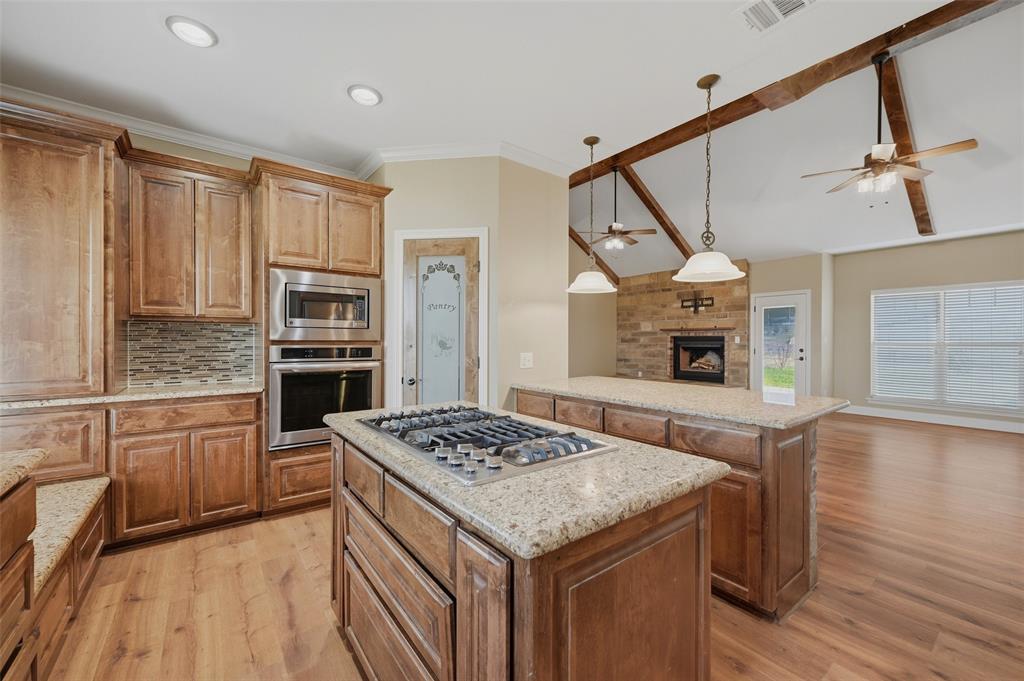 785 Schneider Road Howe, TX 75459 - Photo 14 of 40 a kitchen with a stove a sink and a refrigerator