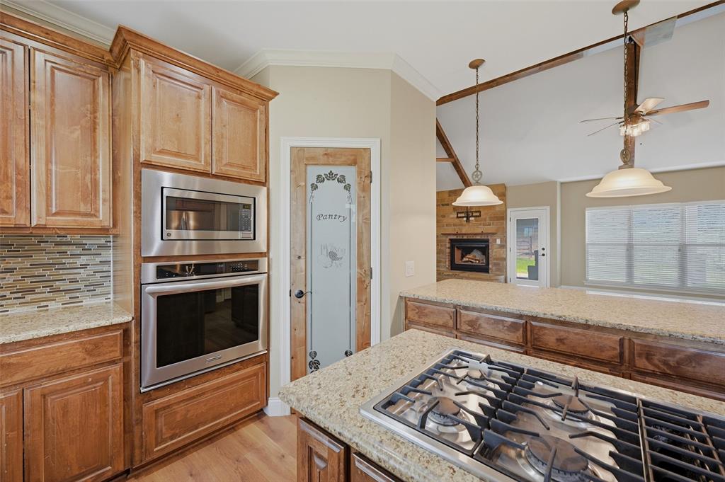 785 Schneider Road Howe, TX 75459 - Photo 15 of 40 a kitchen with stainless steel appliances granite countertop a stove and a refrigerator