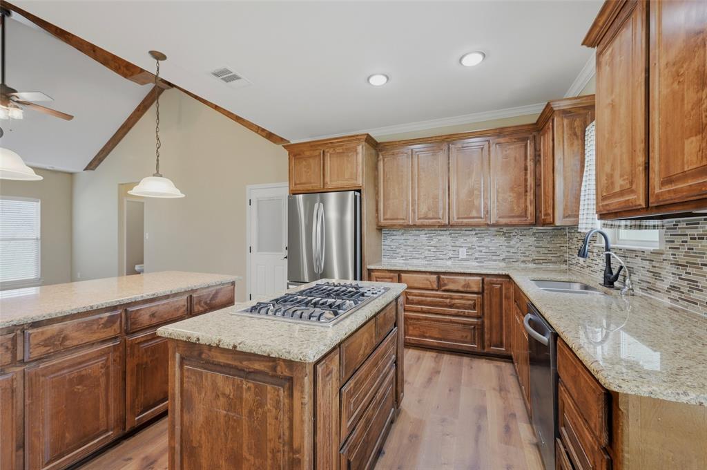 785 Schneider Road Howe, TX 75459 - Photo 17 of 40 a kitchen that has a sink and a stove in it