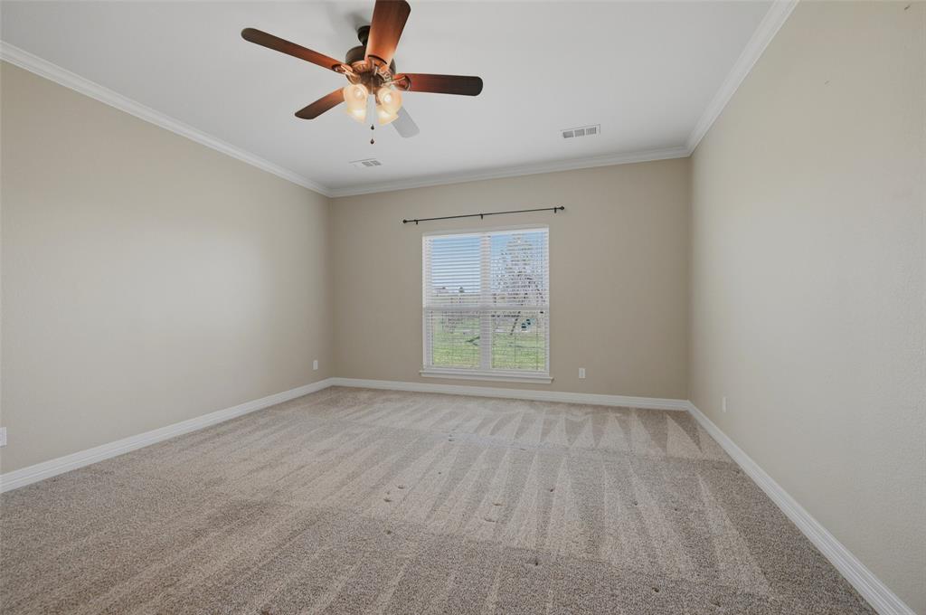 785 Schneider Road Howe, TX 75459 - Photo 26 of 40 an empty room with a window and a fan