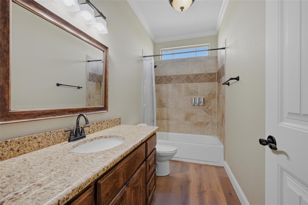 785 Schneider Road Howe, TX 75459 - Photo 27 of 40 a bathroom with a granite countertop sink a mirror and shower