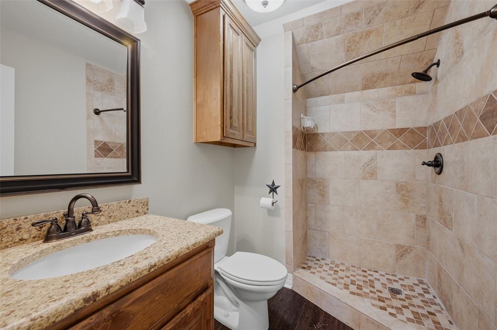 785 Schneider Road Howe, TX 75459 - Photo 31 of 40 a bathroom with a granite countertop sink toilet and shower
