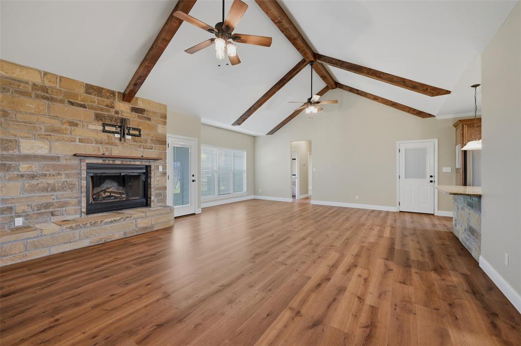 785 Schneider Road Howe, TX 75459 - Photo 7 of 40 a view of empty room with wooden floor and fireplace