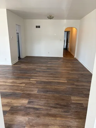 a view of a room with wooden floor
