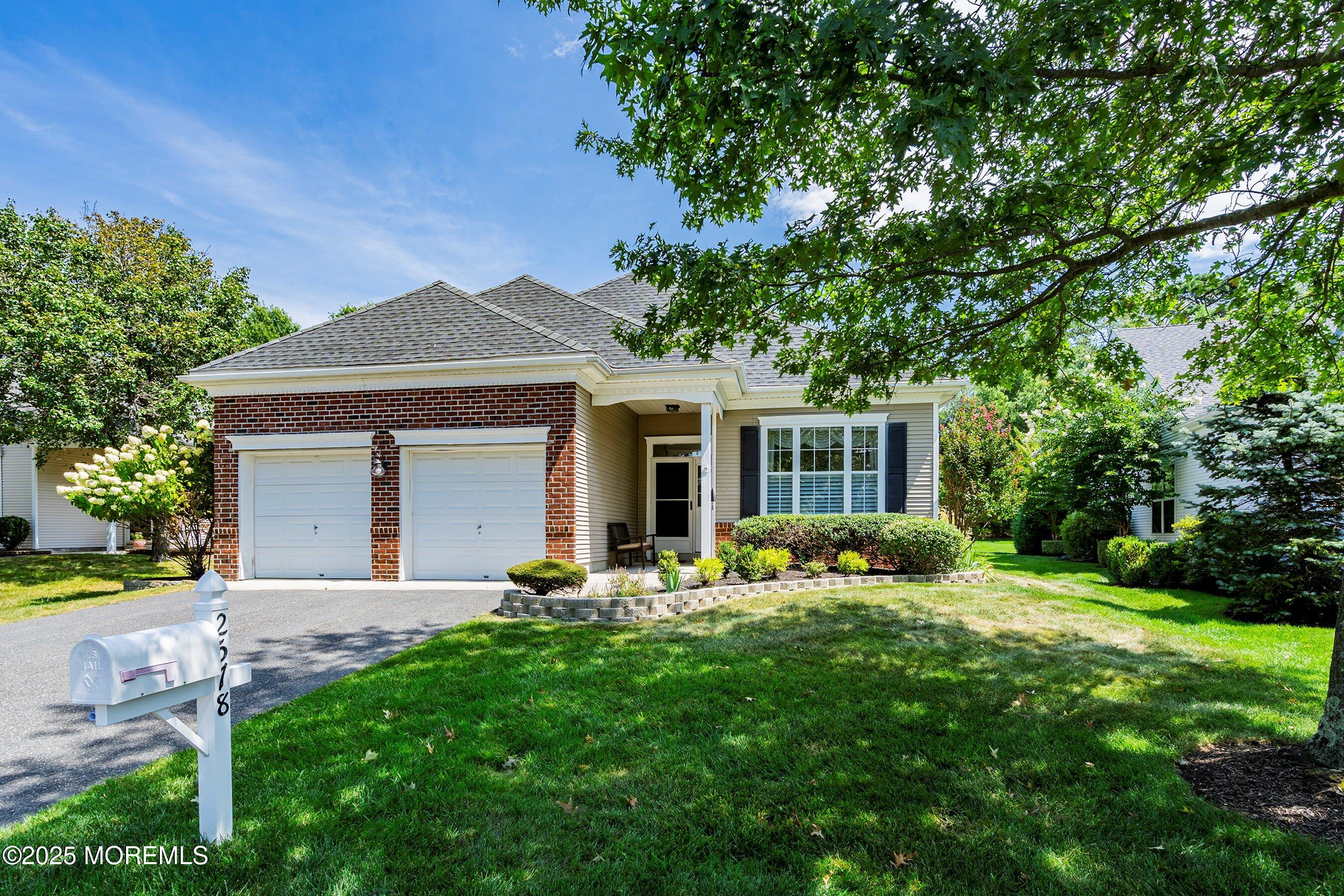 a front view of house with yard and green space