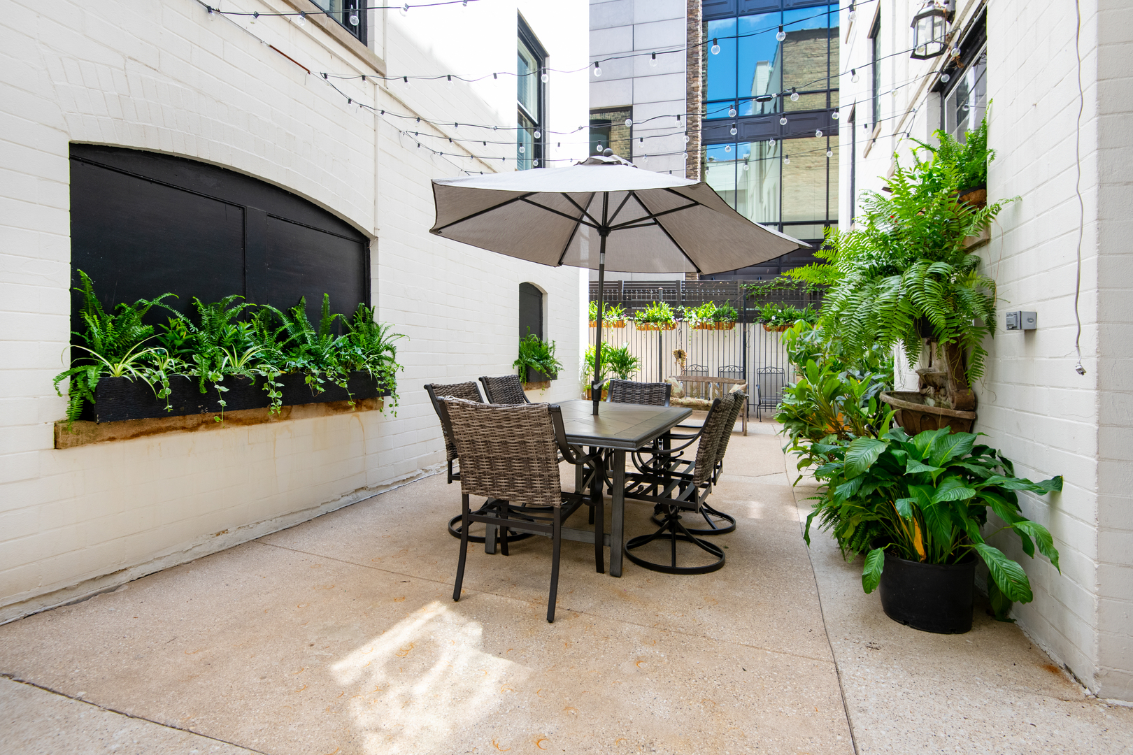 1235 North Astor Street, Unit 2S Chicago, IL 60610 - Photo 21 of 21 a view of a tables and chairs under an umbrella in the patio