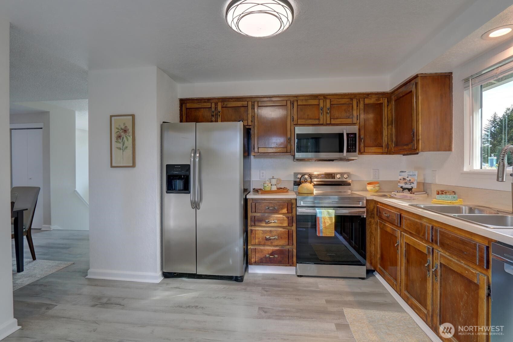 2507 173rd Place Southeast Bothell, WA 98012 - Photo 11 of 30 a kitchen with stainless steel appliances granite countertop a refrigerator stove and sink