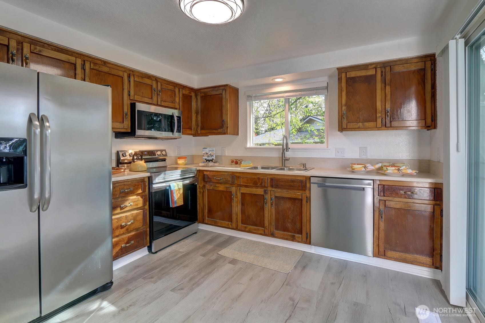 2507 173rd Place Southeast Bothell, WA 98012 - Photo 12 of 30 a kitchen with stainless steel appliances granite countertop a stove a sink and a refrigerator