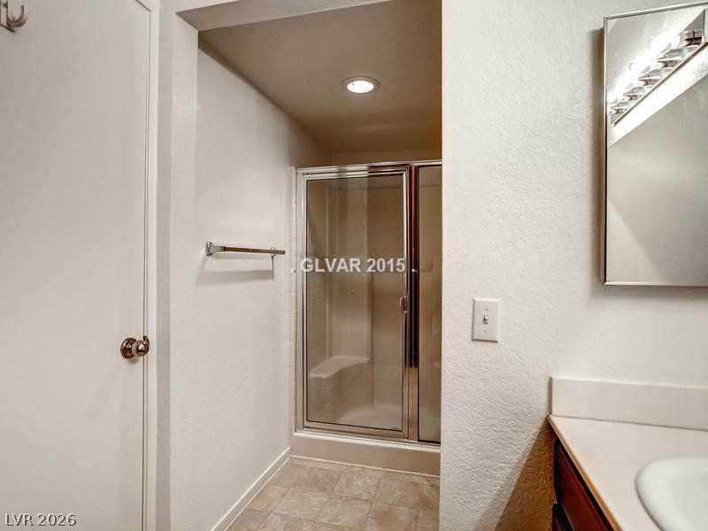 8070 West Russell Road, Unit 2120 Las Vegas, NV 89113 - Photo 9 of 11 A glass-enclosed shower stall anchors this cozy bathroom space.