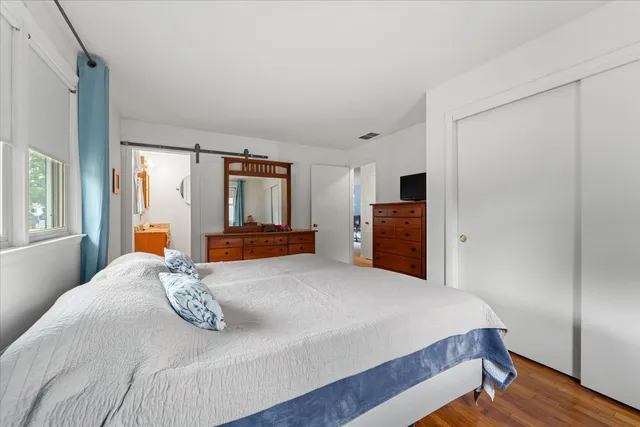 a bedroom with a bed and a dresser