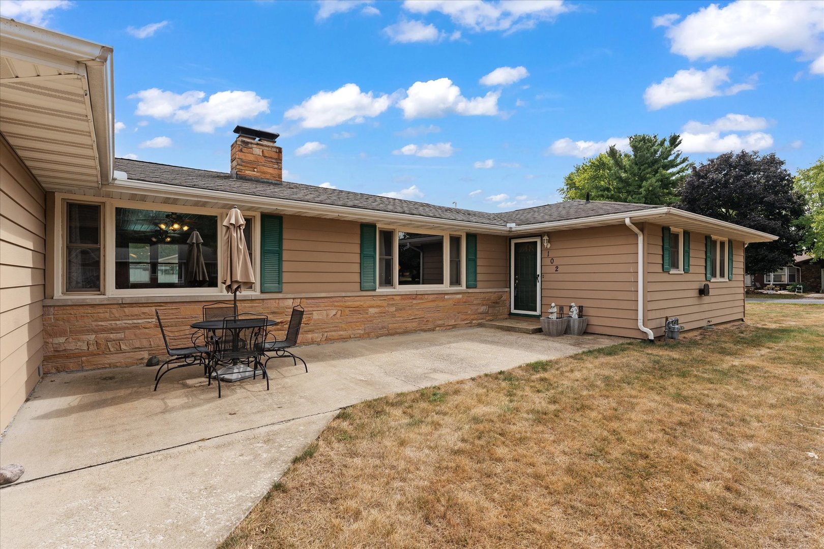 102 North Condit Street Tolono, IL 61880 - Photo 2 of 35 a backyard of a house with table and chairs
