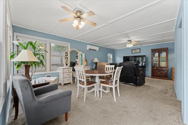 a dining room with furniture a window and a chandelier