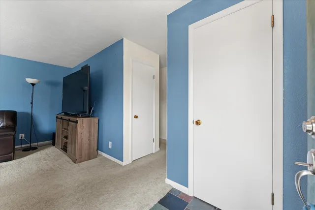 a view of a kitchen with refrigerator and a sink