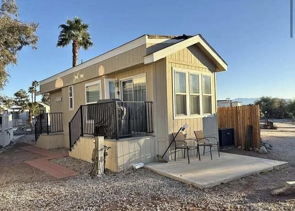 a view of a house with backyard and sitting area