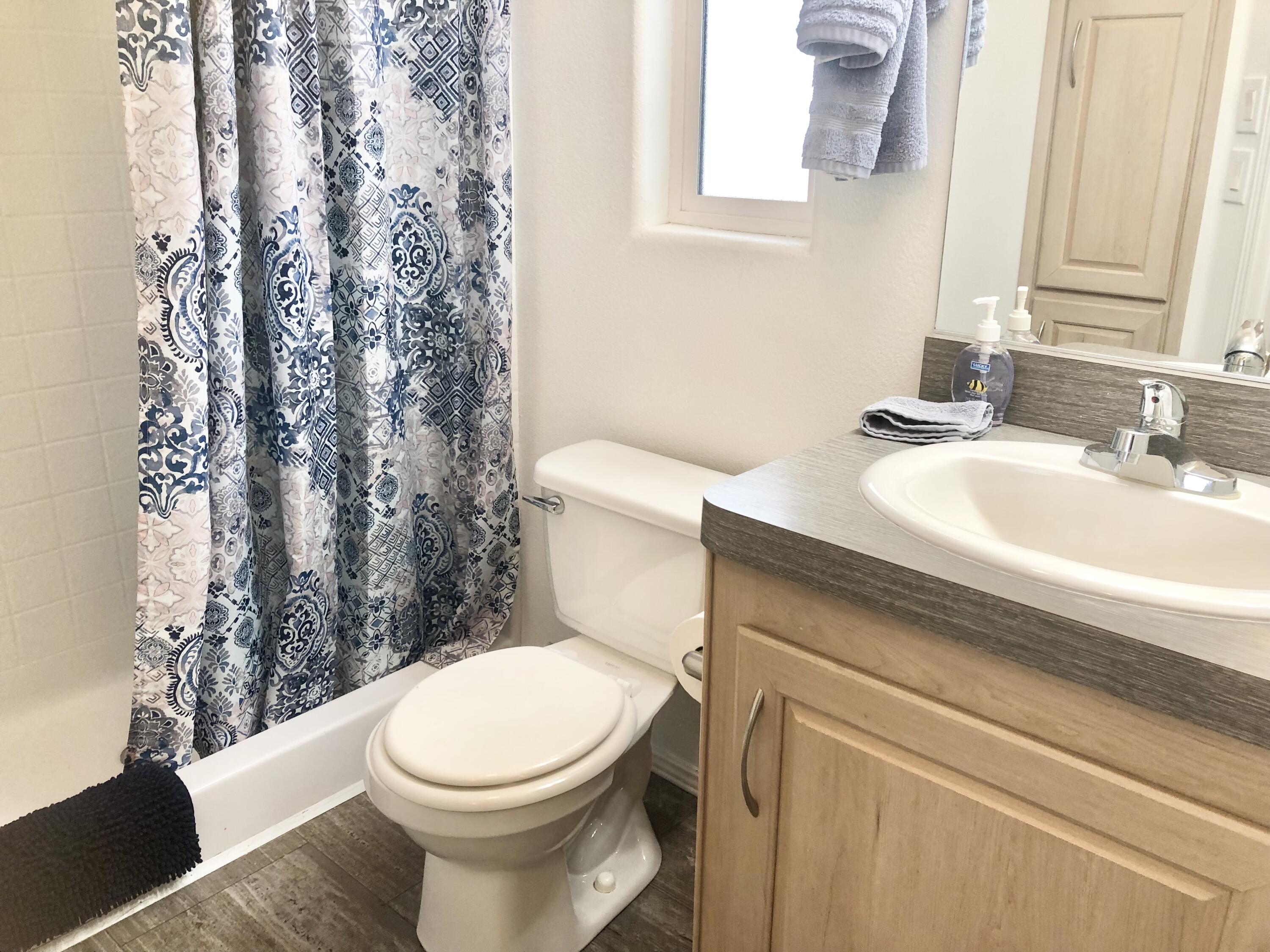 74711 Dillon Road Desert Hot Springs, CA 92241 - Photo 11 of 41 a white toilet sitting next to a bathroom sink