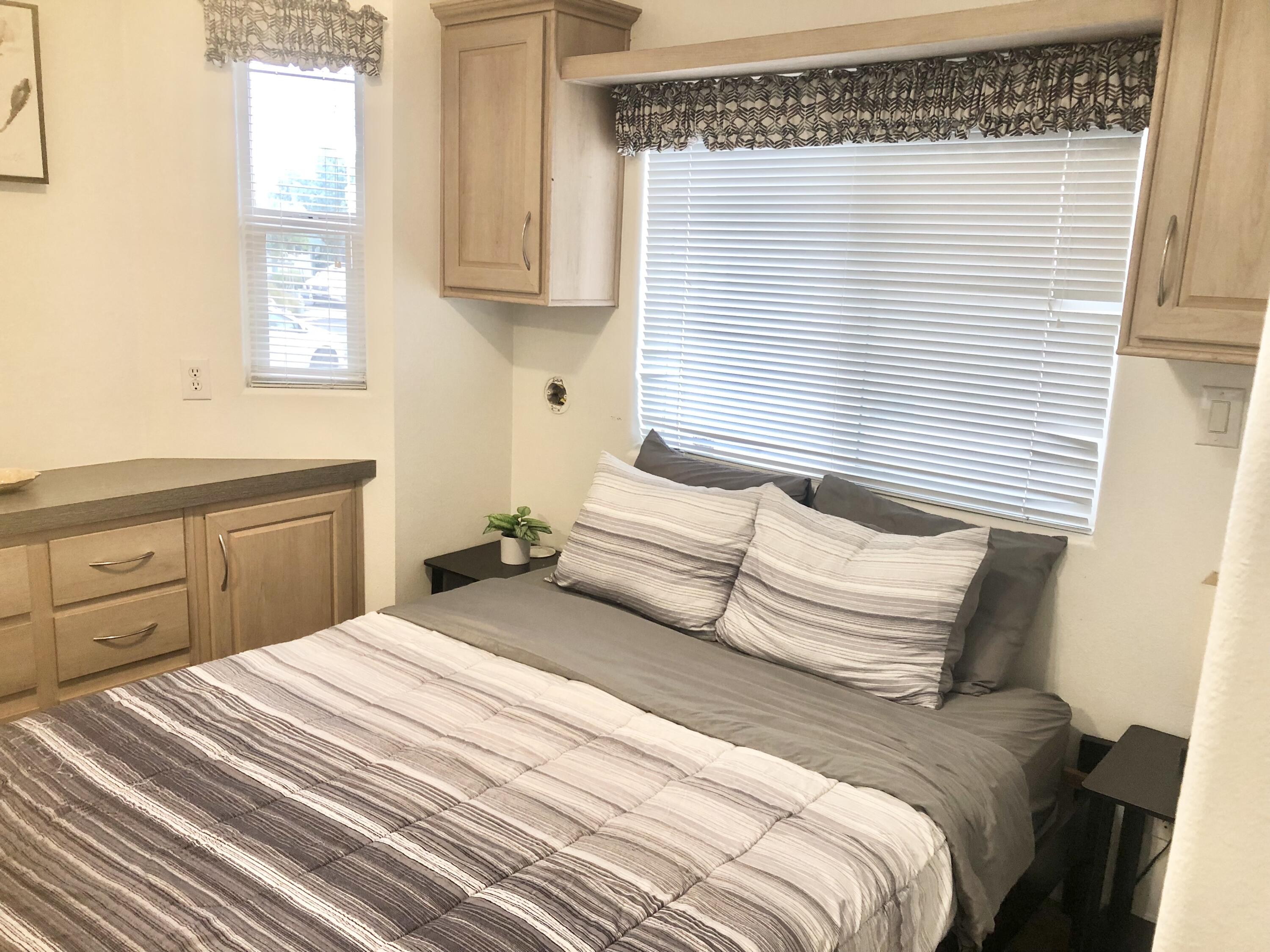 74711 Dillon Road Desert Hot Springs, CA 92241 - Photo 12 of 41 a bedroom with a large bed and a window