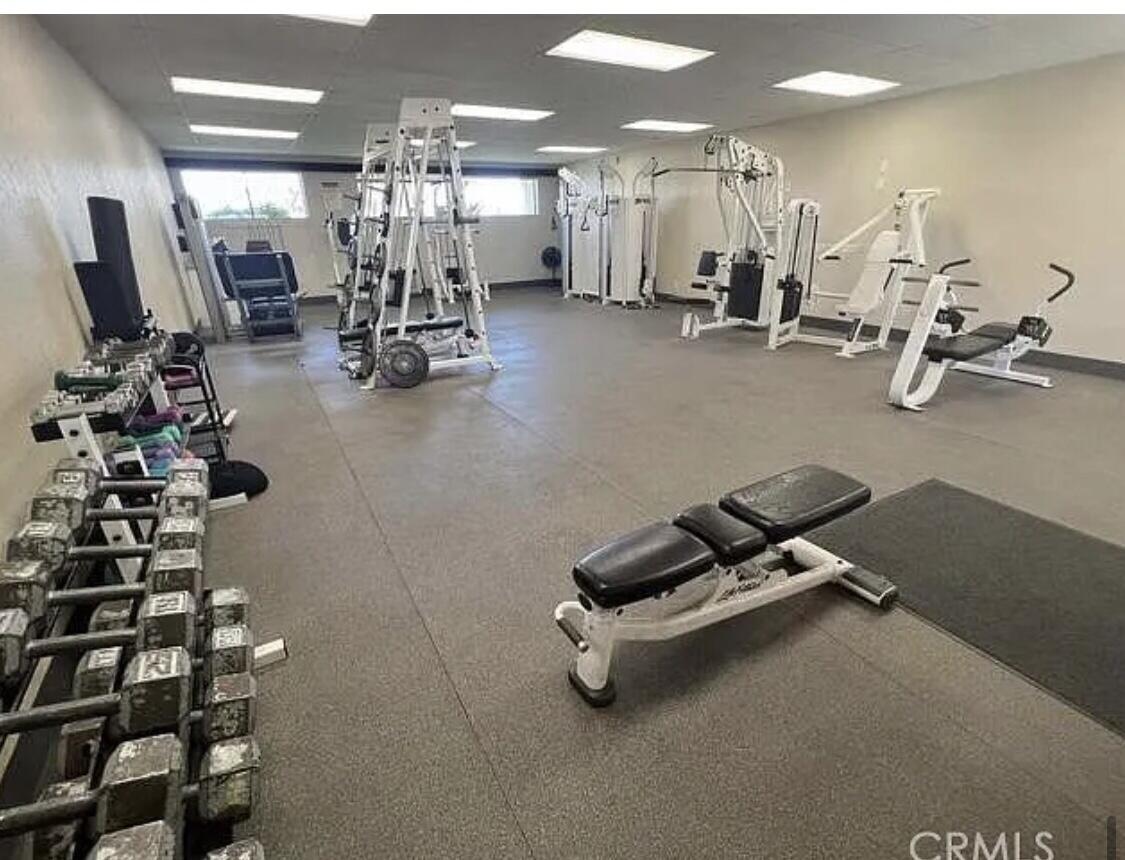 74711 Dillon Road Desert Hot Springs, CA 92241 - Photo 15 of 41 a room with gym equipment and mirrors