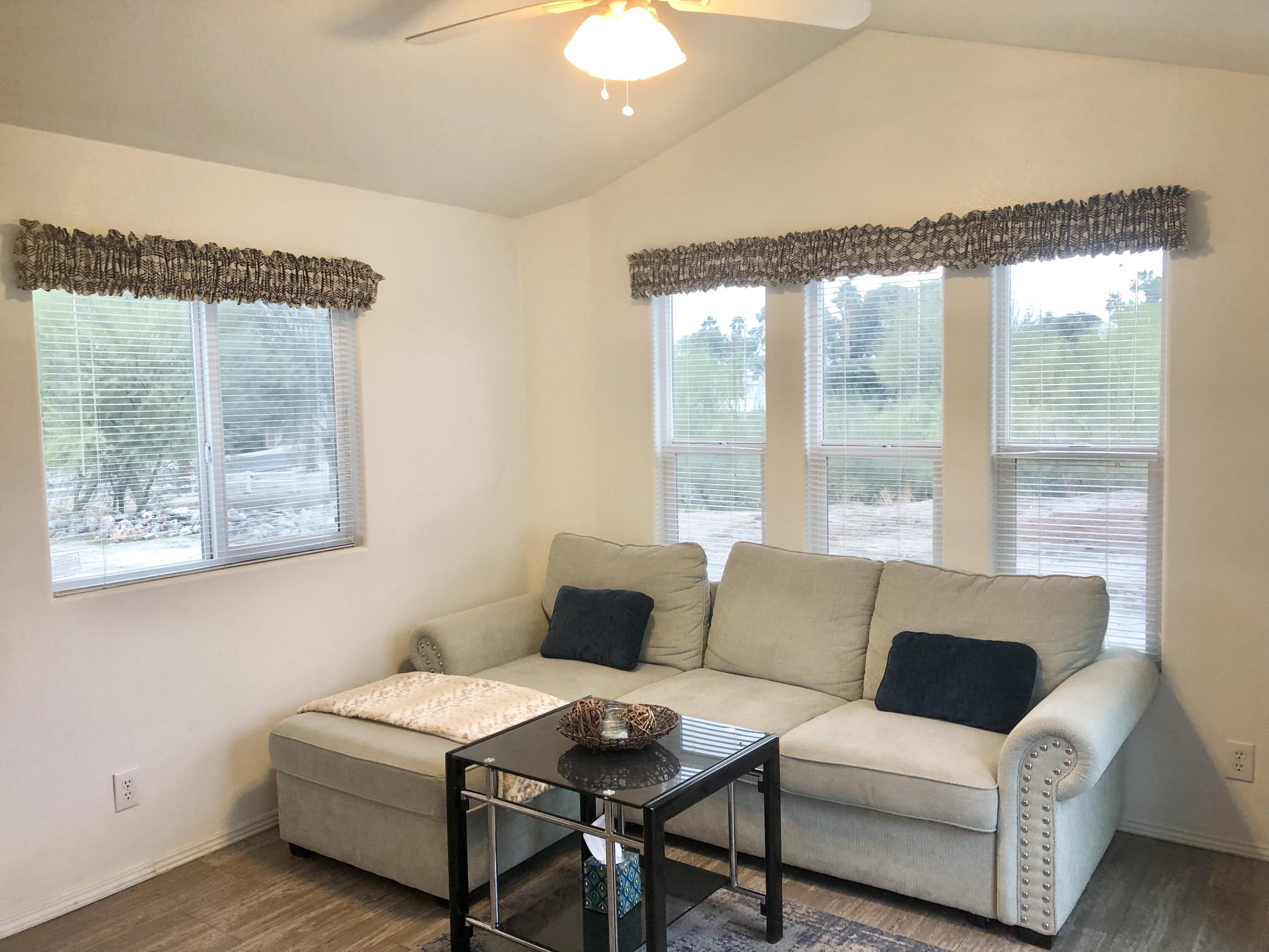 74711 Dillon Road Desert Hot Springs, CA 92241 - Photo 2 of 41 a living room with furniture and a large window