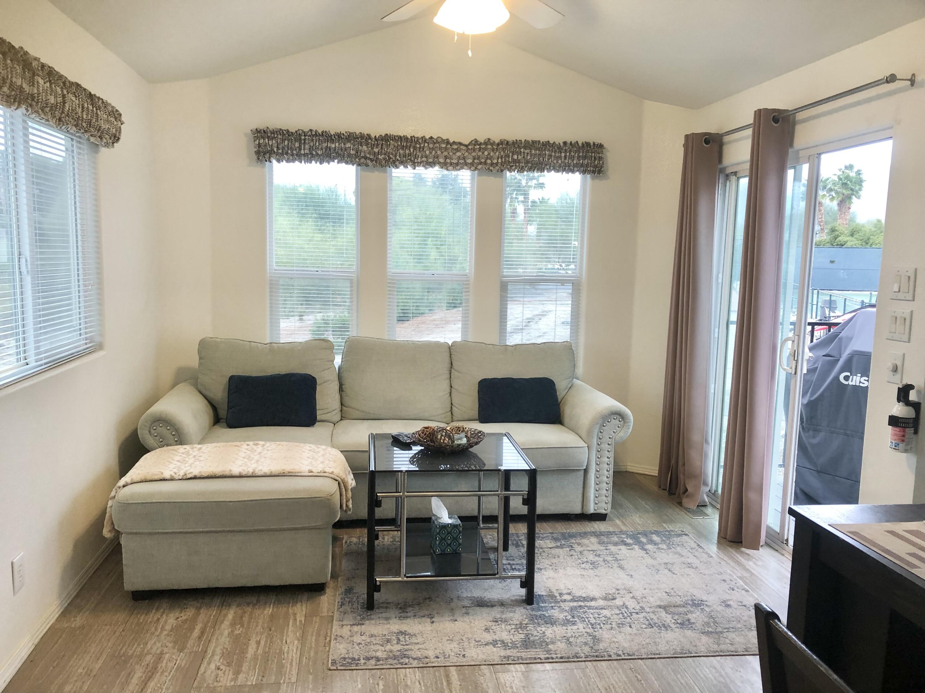 74711 Dillon Road Desert Hot Springs, CA 92241 - Photo 3 of 41 a living room with furniture and large windows