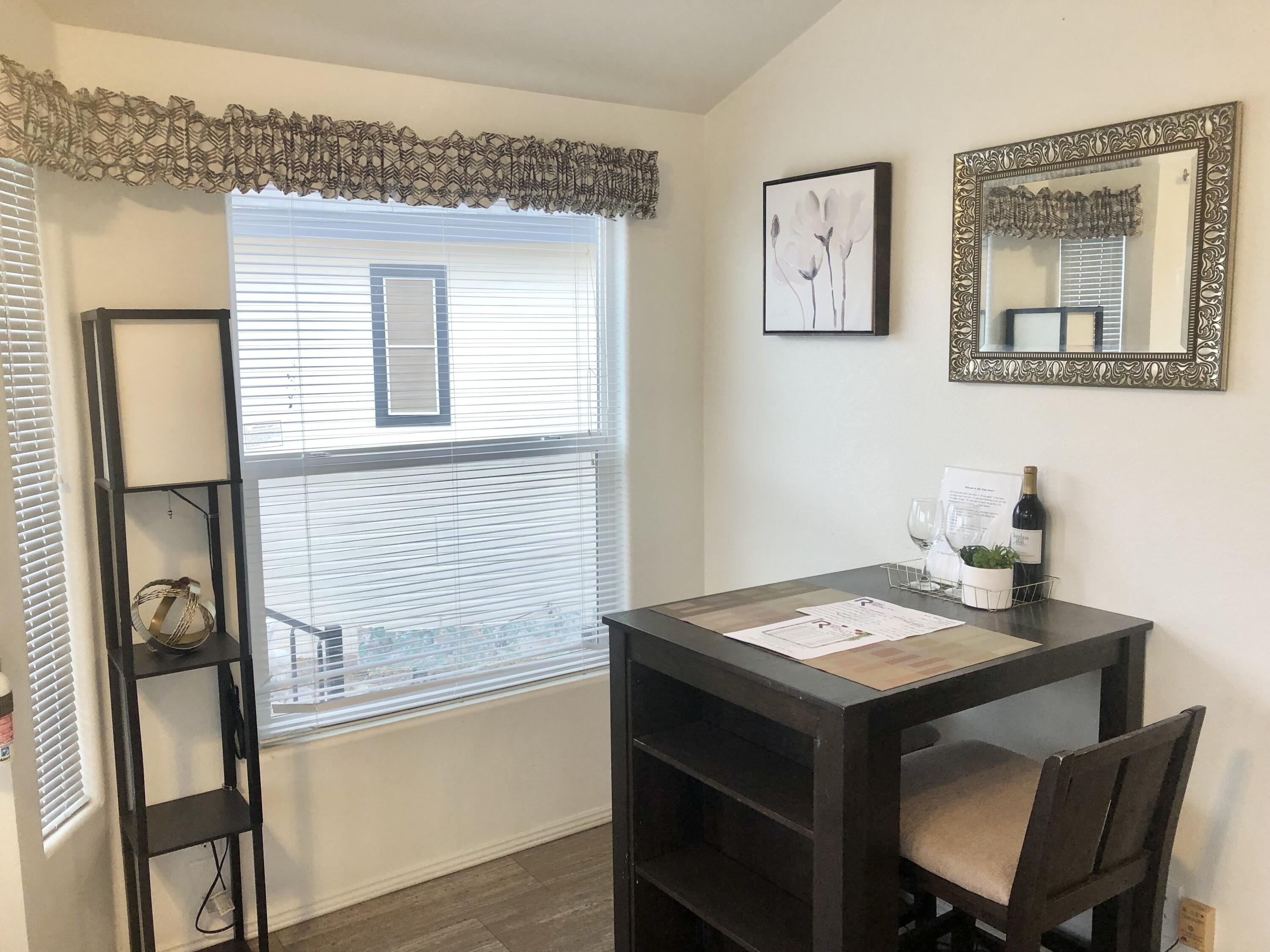 74711 Dillon Road Desert Hot Springs, CA 92241 - Photo 5 of 41 a view of a dining room with furniture and wooden floor