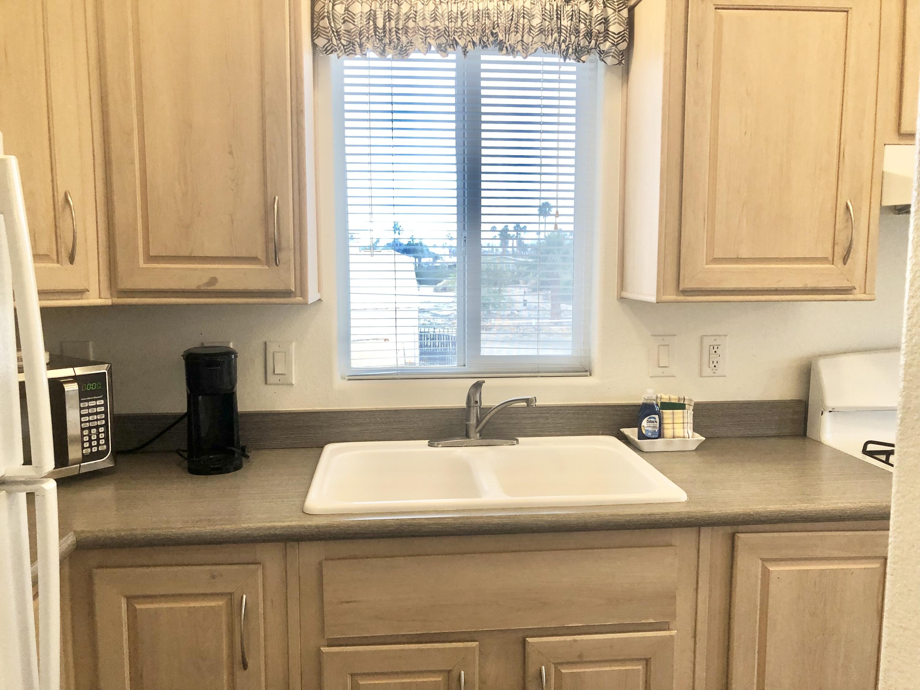 74711 Dillon Road Desert Hot Springs, CA 92241 - Photo 9 of 41 a kitchen with a sink and cabinets