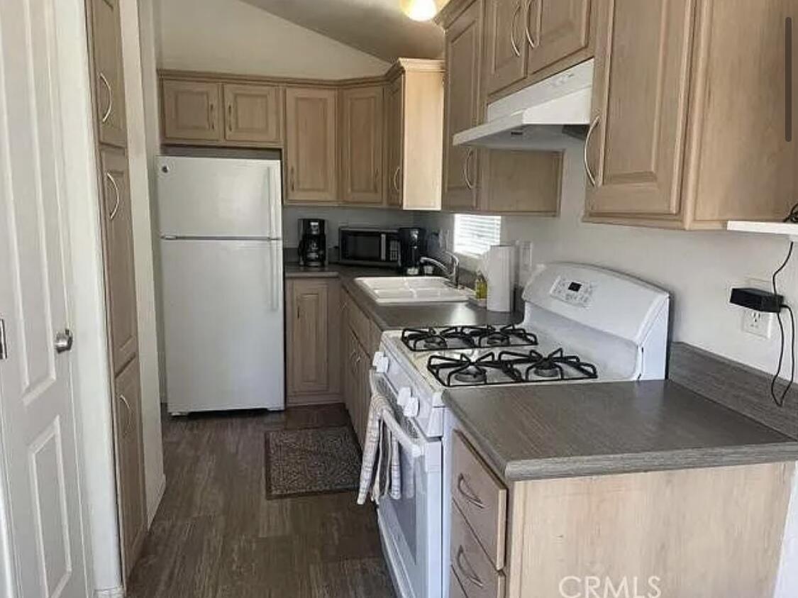 74711 Dillon Road Desert Hot Springs, CA 92241 - Photo 10 of 41 a kitchen with a stove a refrigerator and a sink