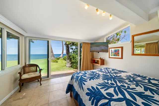 a bedroom with a bed and a painting on the wall