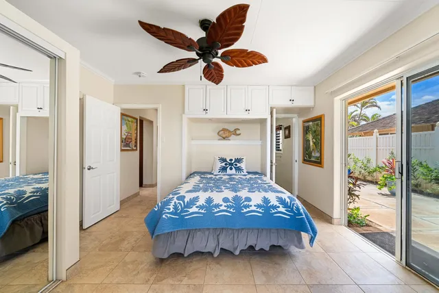 a bedroom with a bed and a dresser with rug