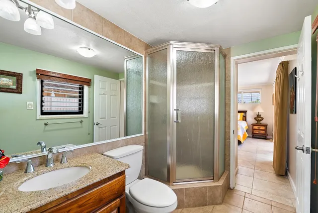 a bed sitting in a spacious bedroom next to a window