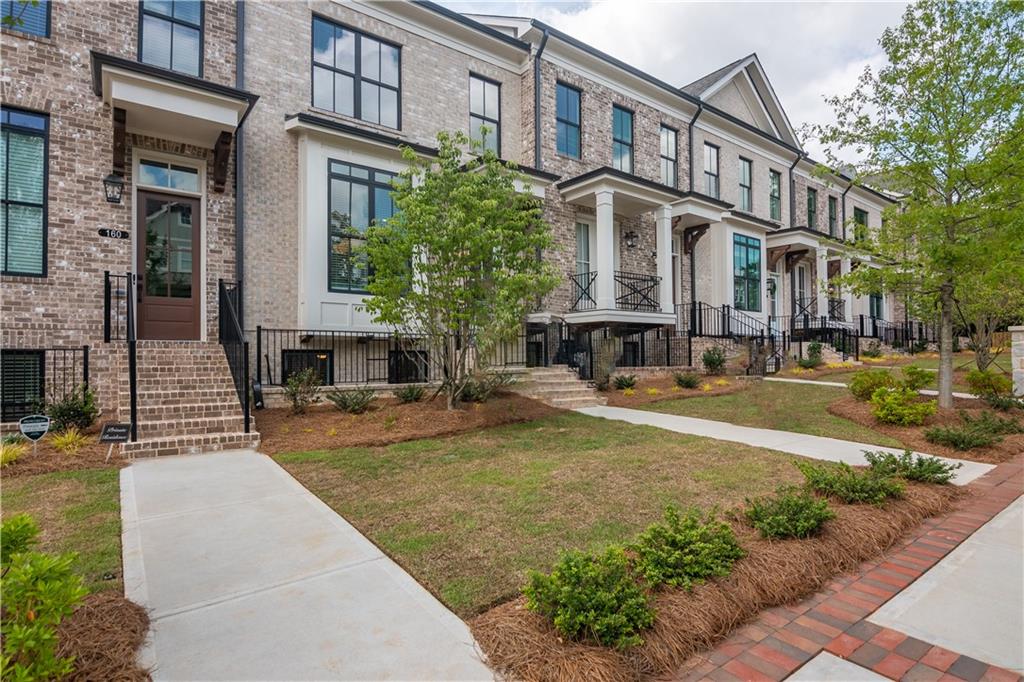 150 Briscoe Way, Unit 26 Alpharetta, GA 30009 - Photo 1 of 1 a view of a building with a garden