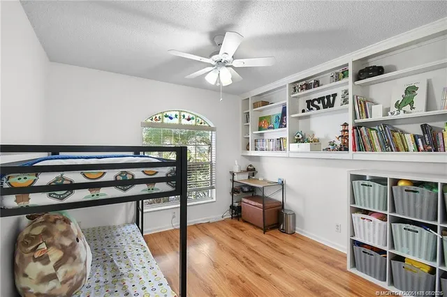 a view of room with wooden floor and book shelf